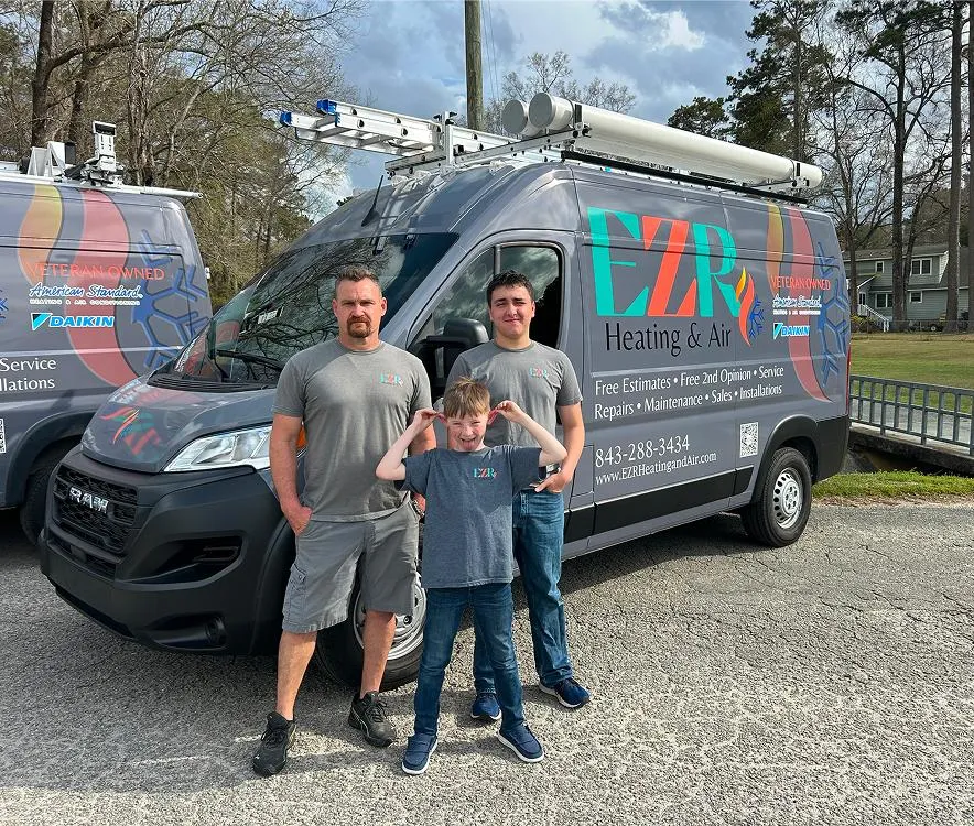 Brandon and family in front of EZR Heating & Air service van